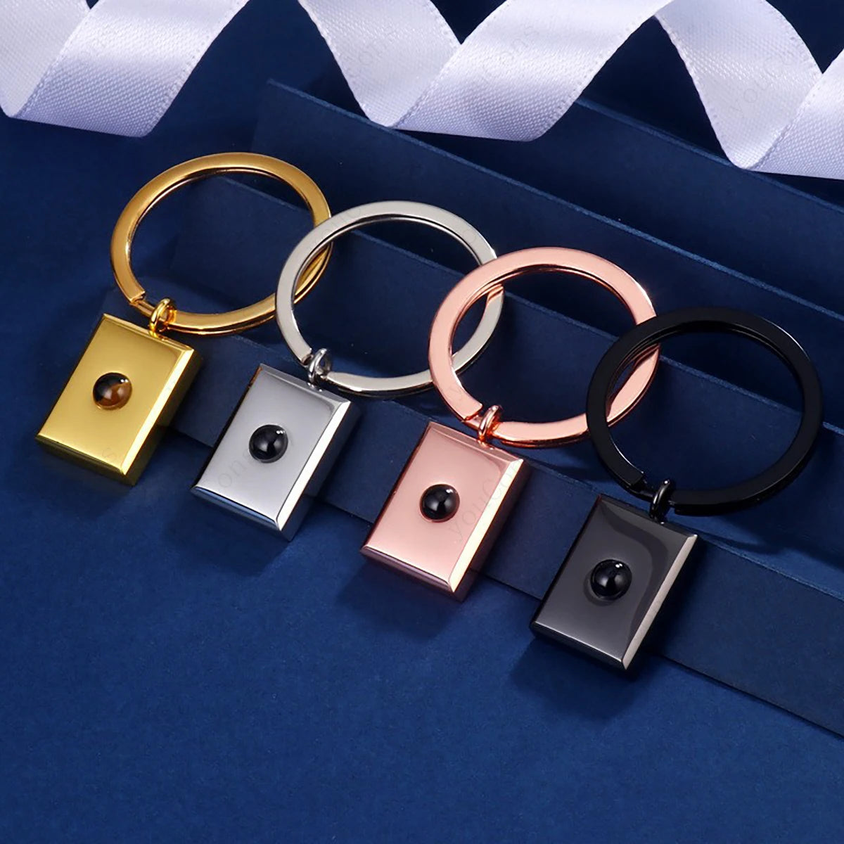 Personalisierter Foto Projektions Schlüsselanhänger aus Edelstahl mit eigenem Bild in Silber, Gold, Schwarz und Roségold.